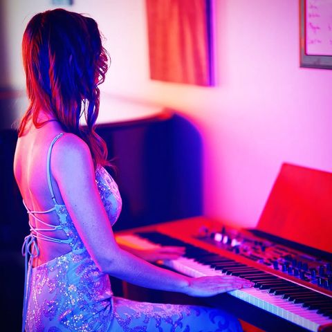 Awake & Dreaming Sasha Kristoff posing with iconic keyboard
